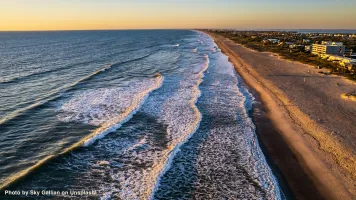  An aerial view of Cocoa Beach and the surf at sunrise..