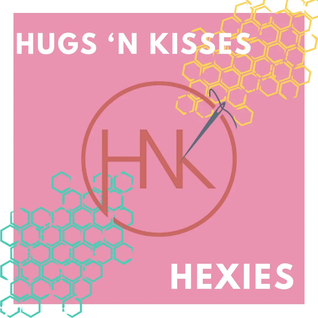 Colorful whimsical quilt with triangular circus tents, toys, and geometric shapes on a pink background bordered with colorful triangles and diamonds. No human shapes or faces.