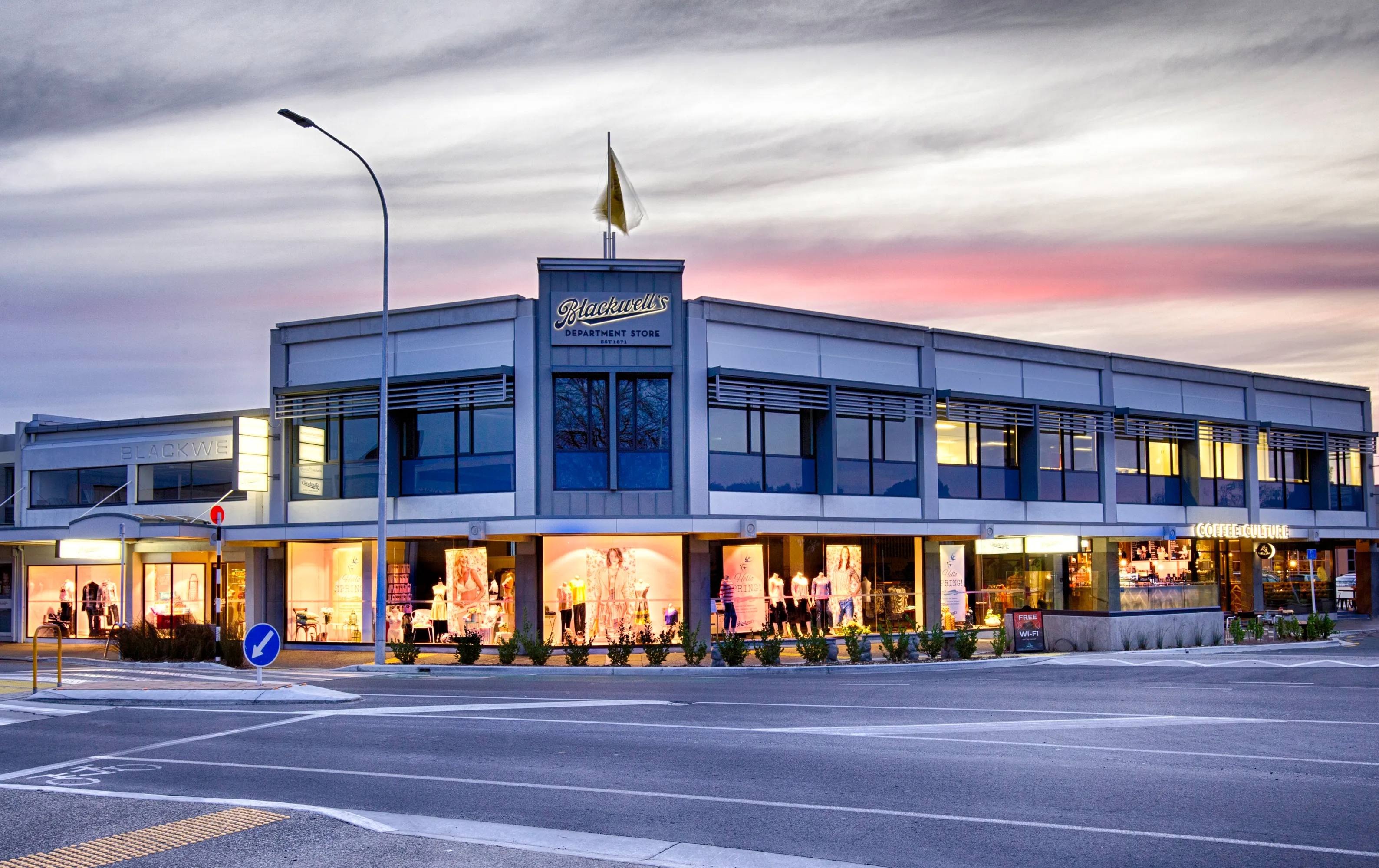 Modern photograph showcasing the current state of the business school with contemporary architecture, advanced technology, and vibrant learning environments. No identifiable individuals should be featured.