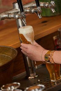 Beer being poured out of beer tap.
