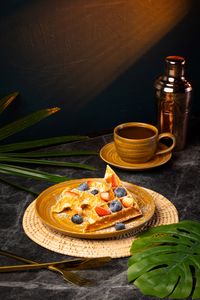 Ricotta waffles with mixed berries and homemade strawberry sauce served as a sweet all-day brunch dessert at Lašė Lašė specialty coffee café in Ari, Bangkok.