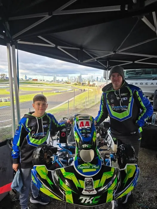 TKC coaching under the tent — Townsville Kart Centre. Image shows racing kart coaching session with driver and coach analyzing performance data. No human shapes visible.